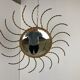 Mid century gold sunburst mirror with convex glass.