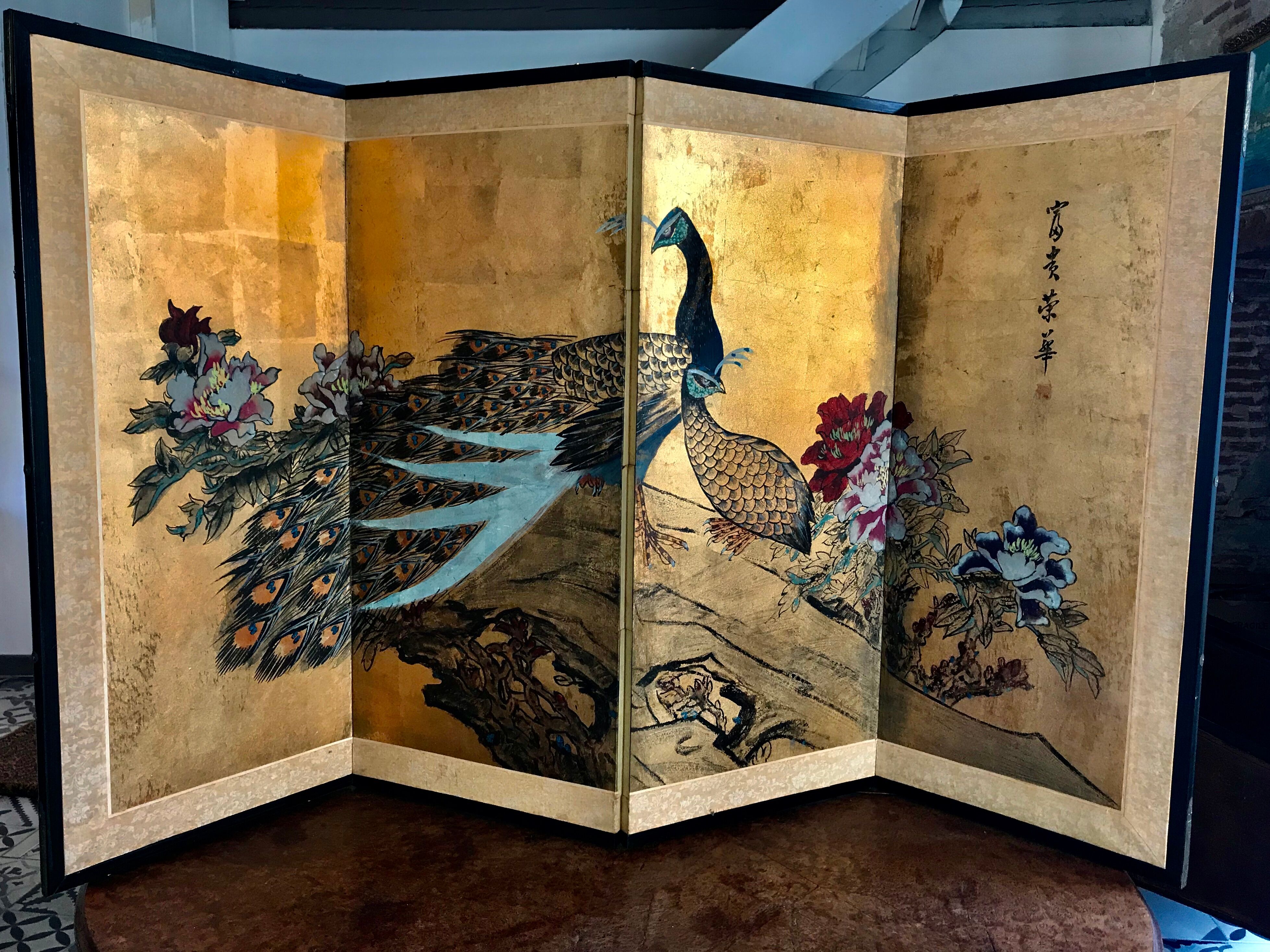 Ancient Chinese screen decorated with peacocks and flowers on gold leaf