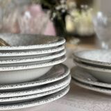 12 speckled ceramic plates.