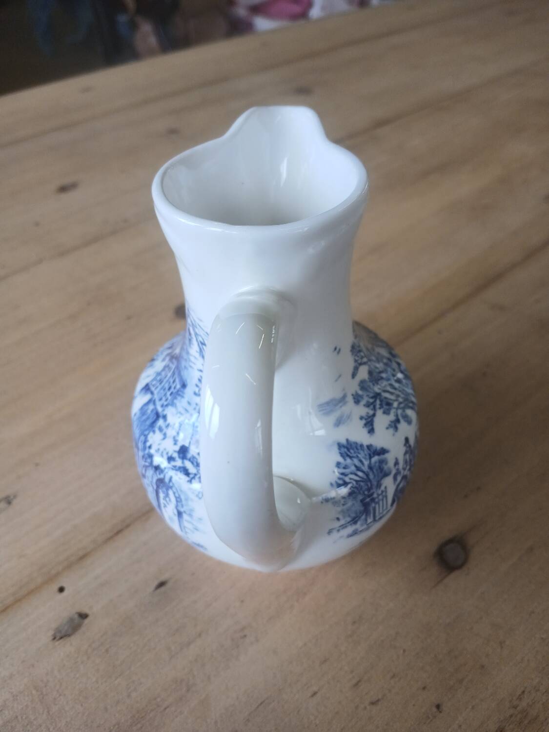 Small old pitcher in iron earth