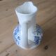 Small old pitcher in iron earth