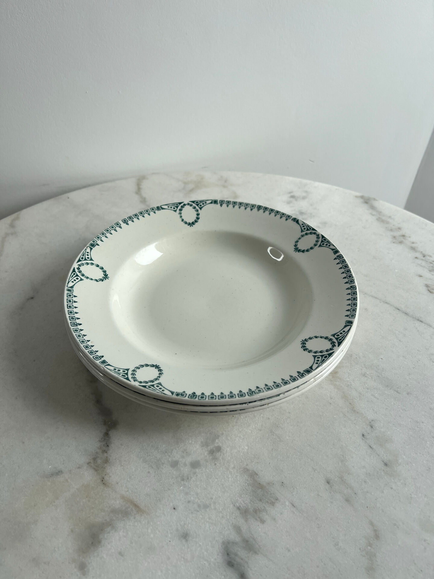 Set of 3 St Amand deep plates with green crown decoration.