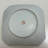 Porcelain plate with several roosters