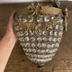 Brass basket chandelier with Louis XVI style pendants.