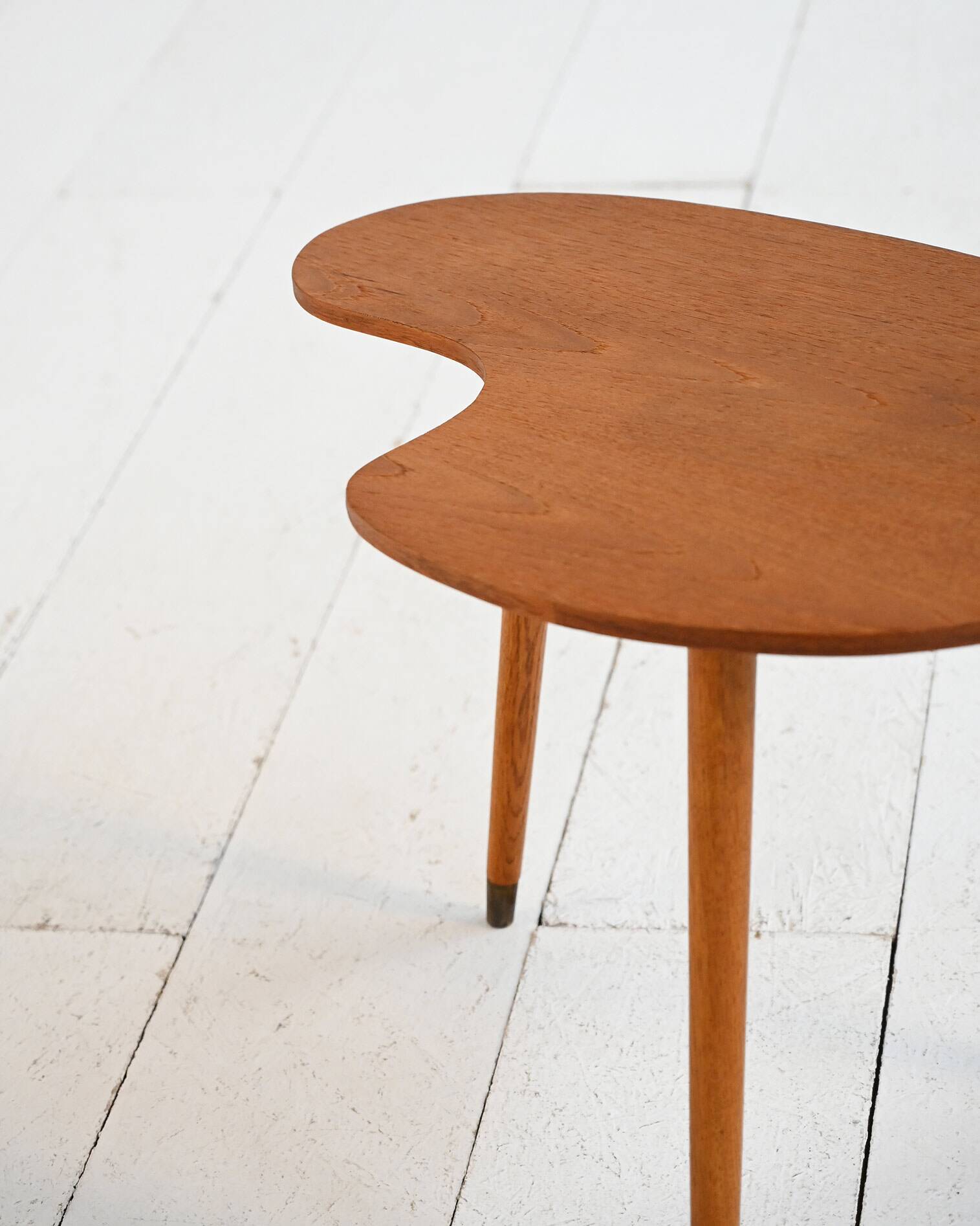 Biomorphic teak and brass side table from the 1950s–1960s
