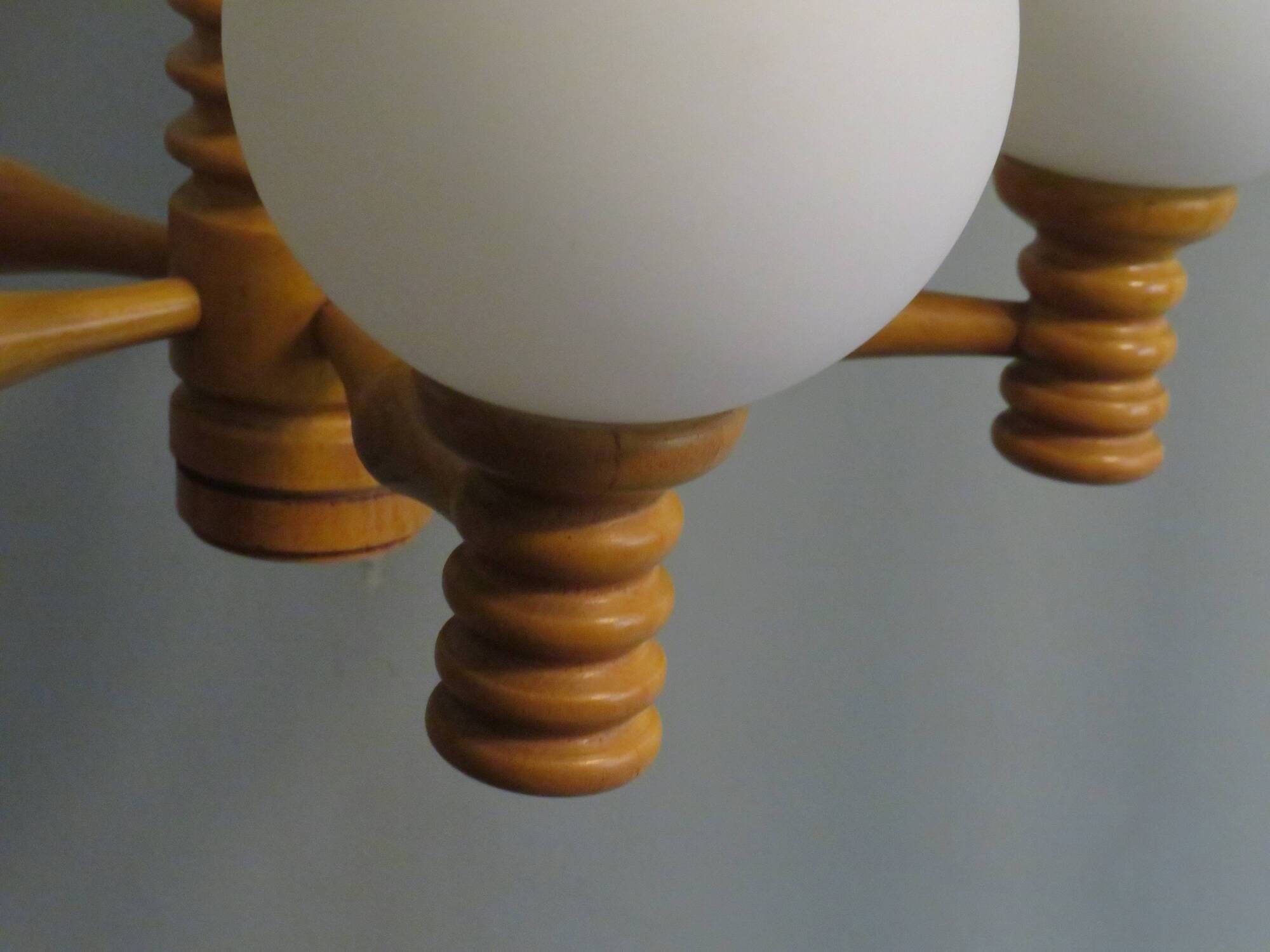 Space age chandelier in 5-arm wood with white frosted opaline glass spheres.
