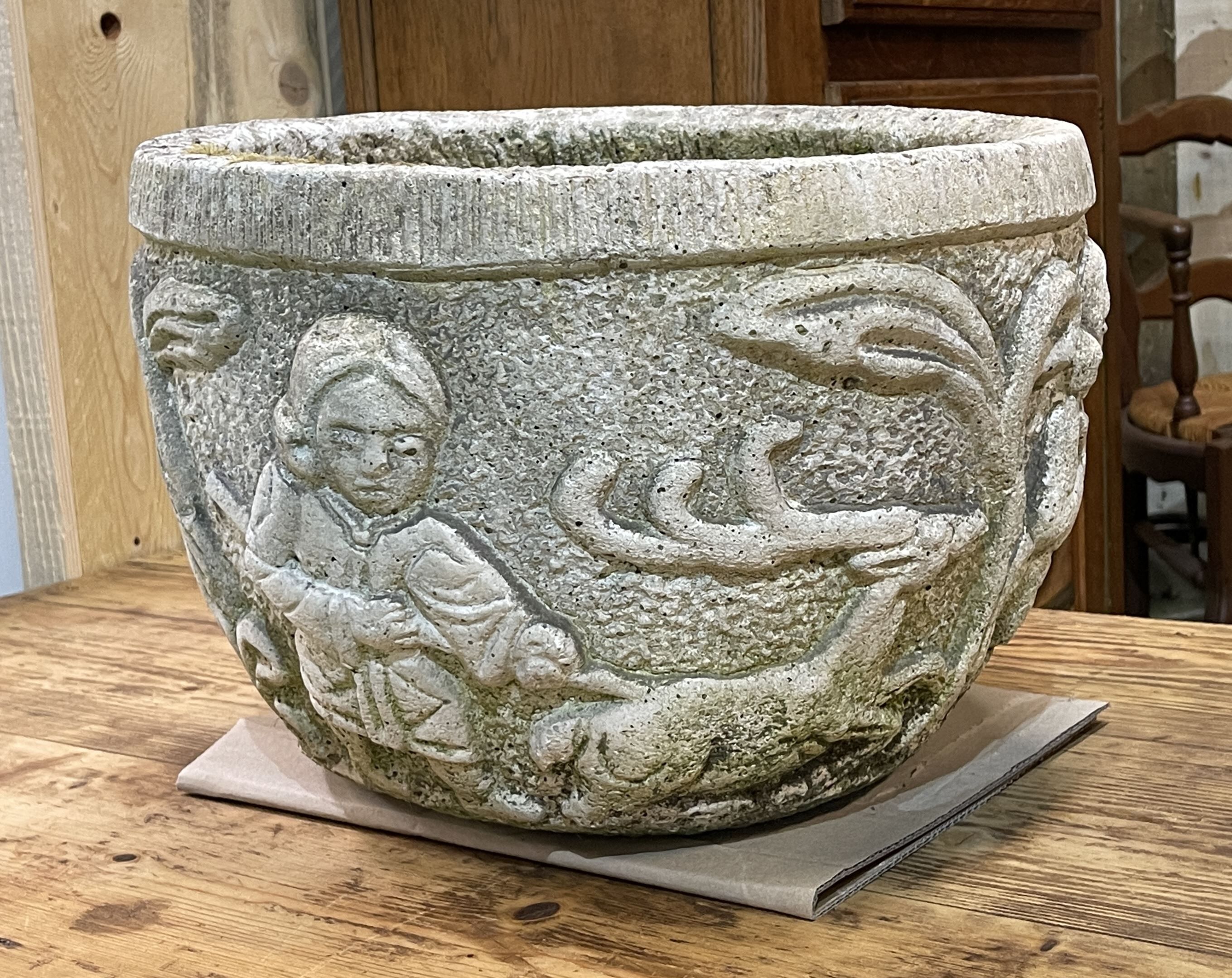 Reconstituted stone planter with hunting decoration