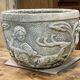 Reconstituted stone planter with hunting decoration