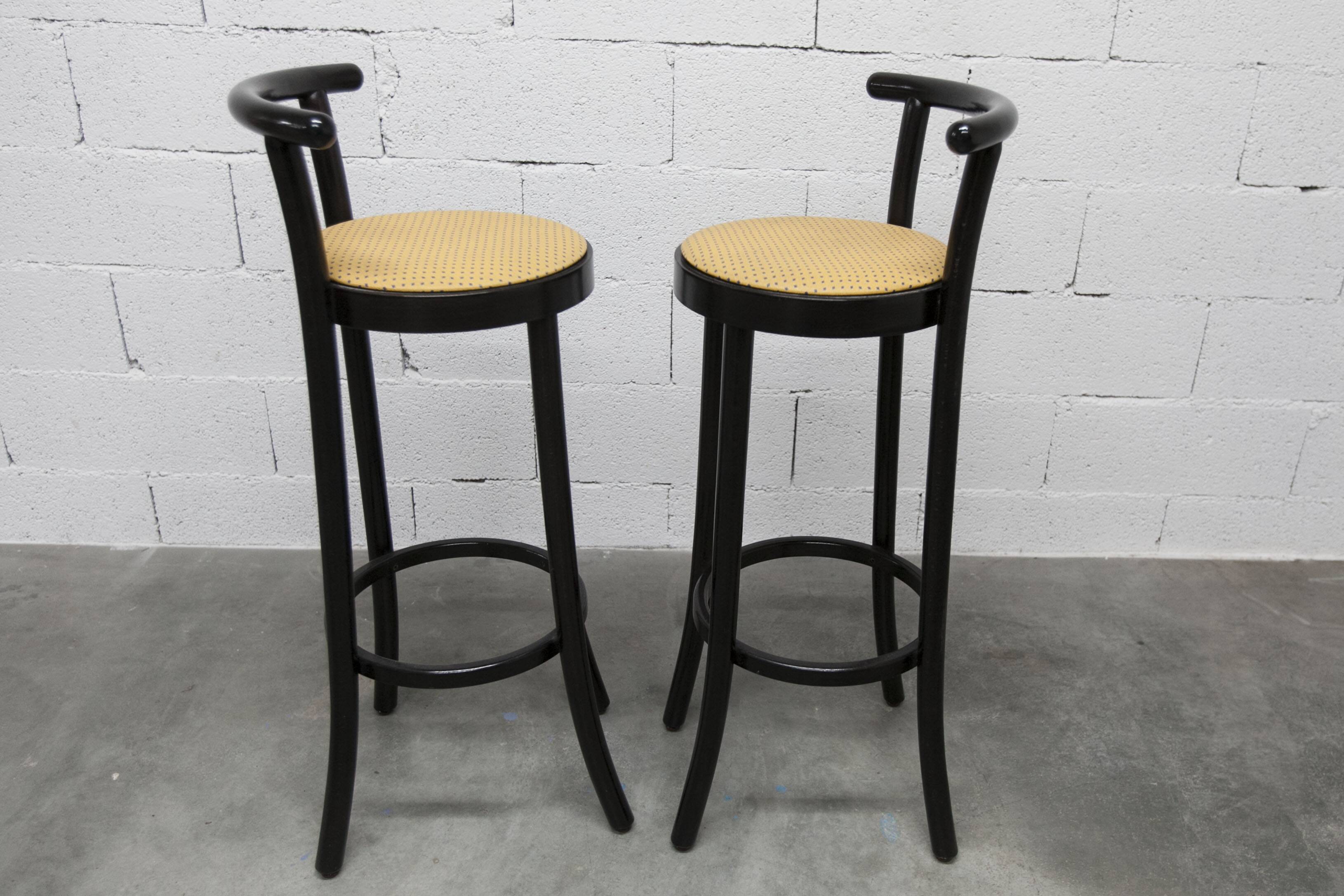 Pair of Baumann Dialog model stools in black and yellow and blue imitation leather, 1990