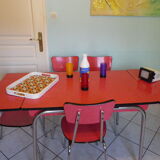 Table in red formica, 4 roc chairs, 2 extension cords, 2 drawers 60