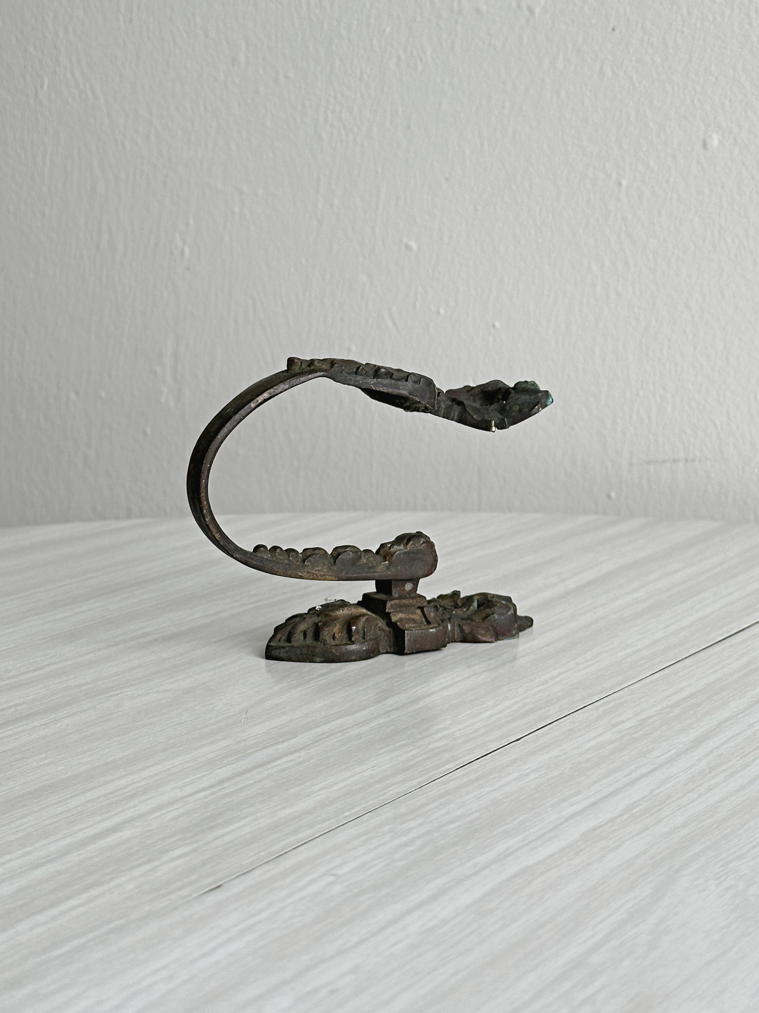 Antique black patinated metal coat hook.