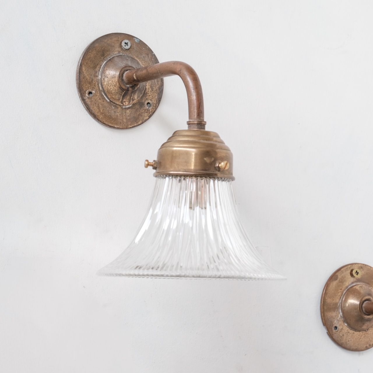 Pair of brass and holophane glass french mid-century wall lights
