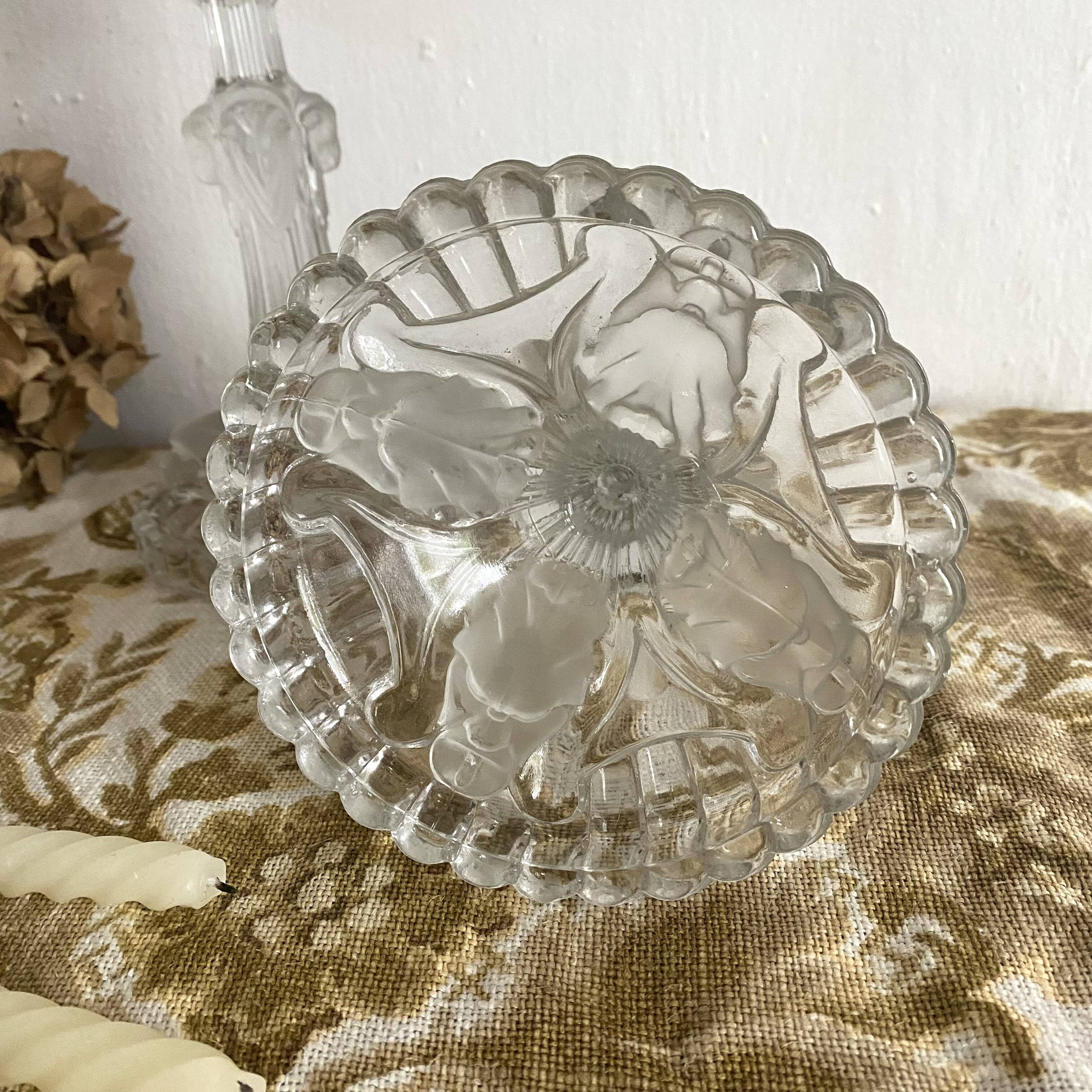 Pair of moulded glass candlesticks, ram heads and masks