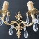 Pair of gilt bronze wall sconces with crystal pendants.