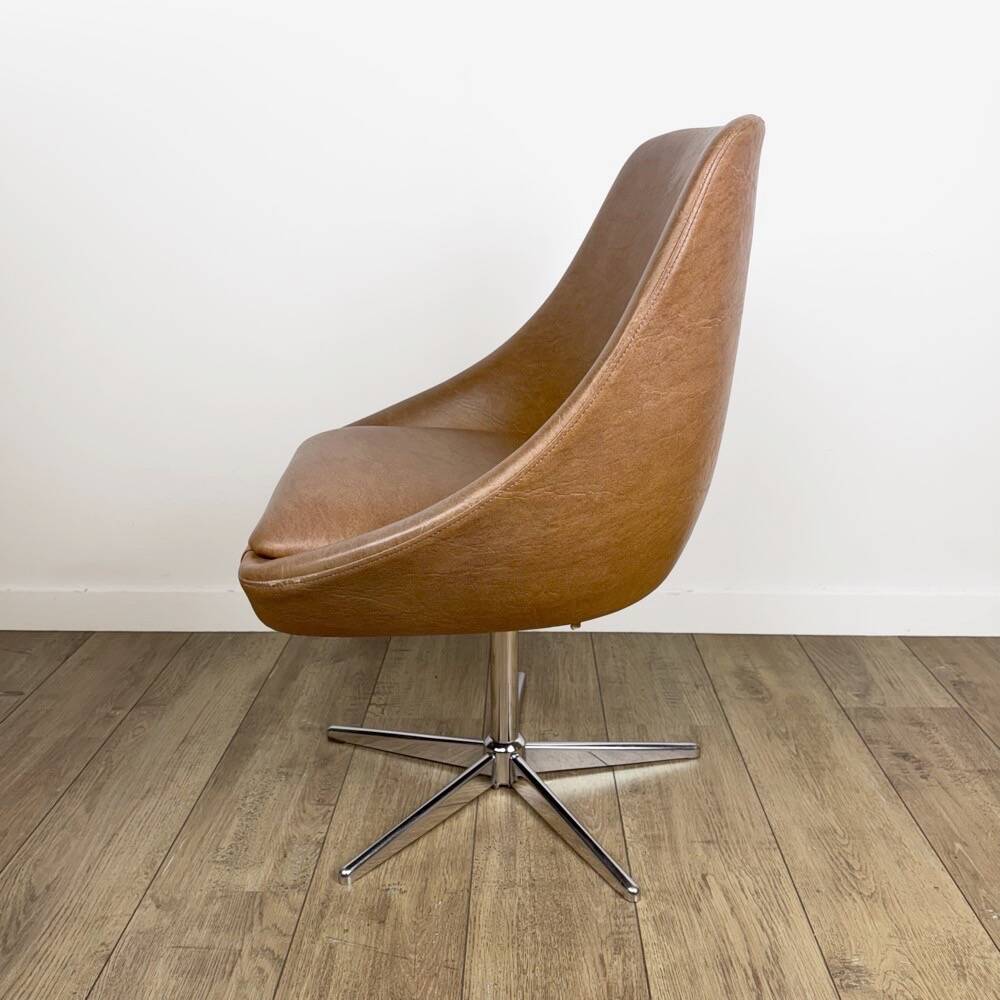 1970s swivel chair with faux leather shell and chrome.