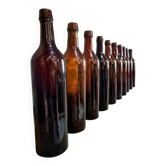 Set of 10 bottles of old Bordeaux French wine in ruby brown glass, 19th century.