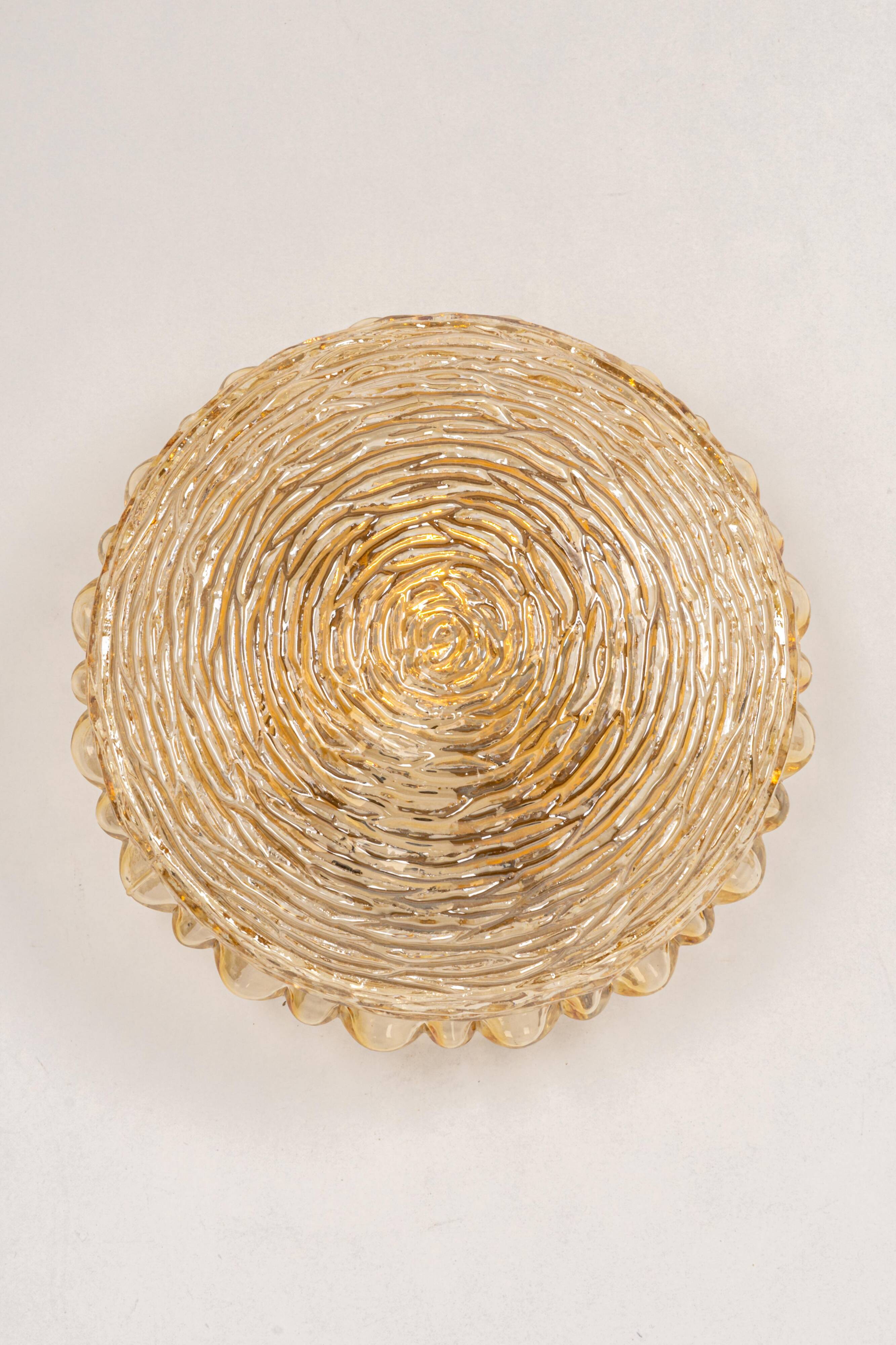 Amber glass wall sconces in the shape of a fingerprint, Germany, 1970s.