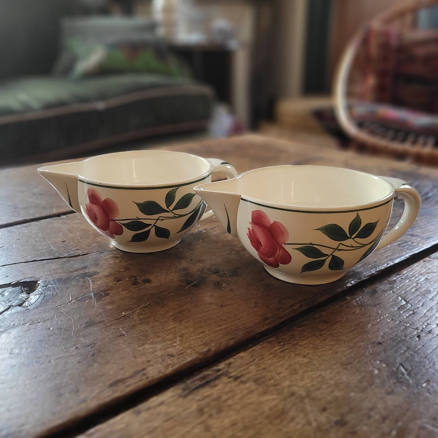 Pair of hand-painted floral-decorated jugs