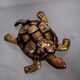 Golden brass turtle in decorative ashtray