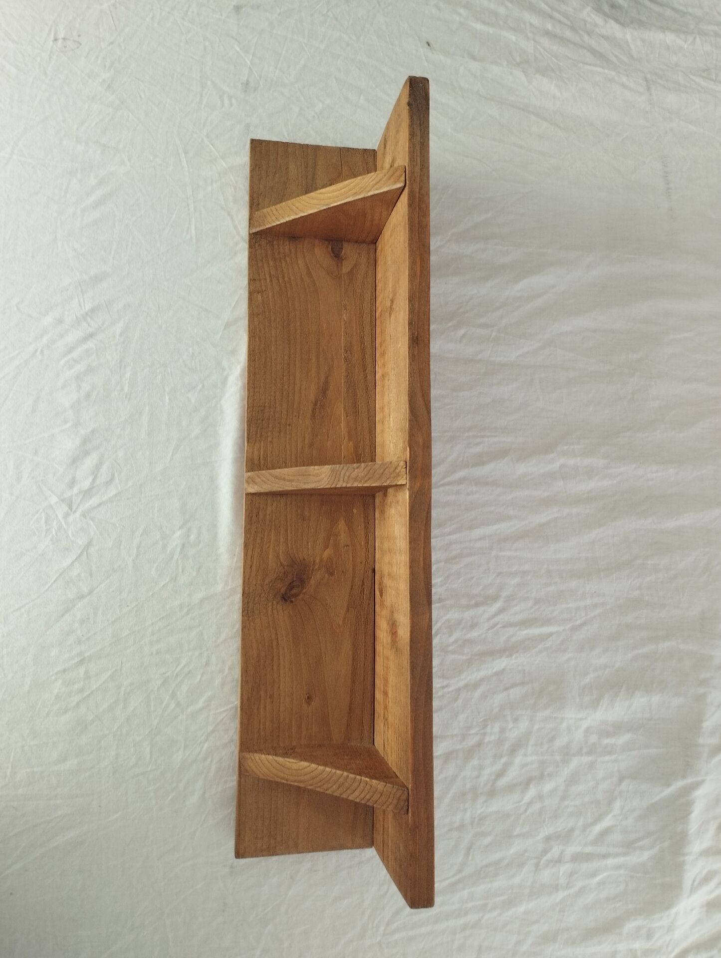 Handcrafted wall shelf in solid fir.
