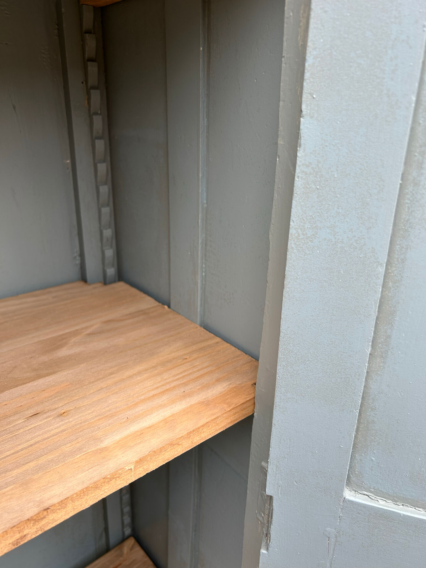 Small antique wardrobe with a faded white patina.