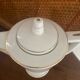 White and gold porcelain coffee pot in art deco style.