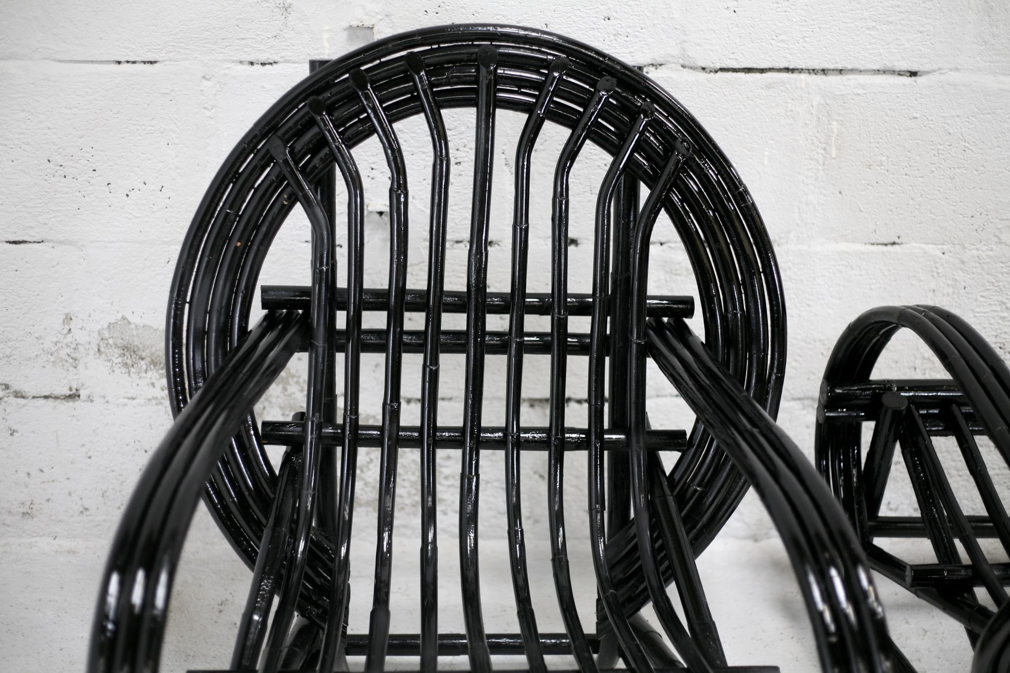 Pair of black lacquered rattan armchairs. France, cira 1960.