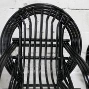 Pair of black lacquered rattan armchairs. France, cira 1960.