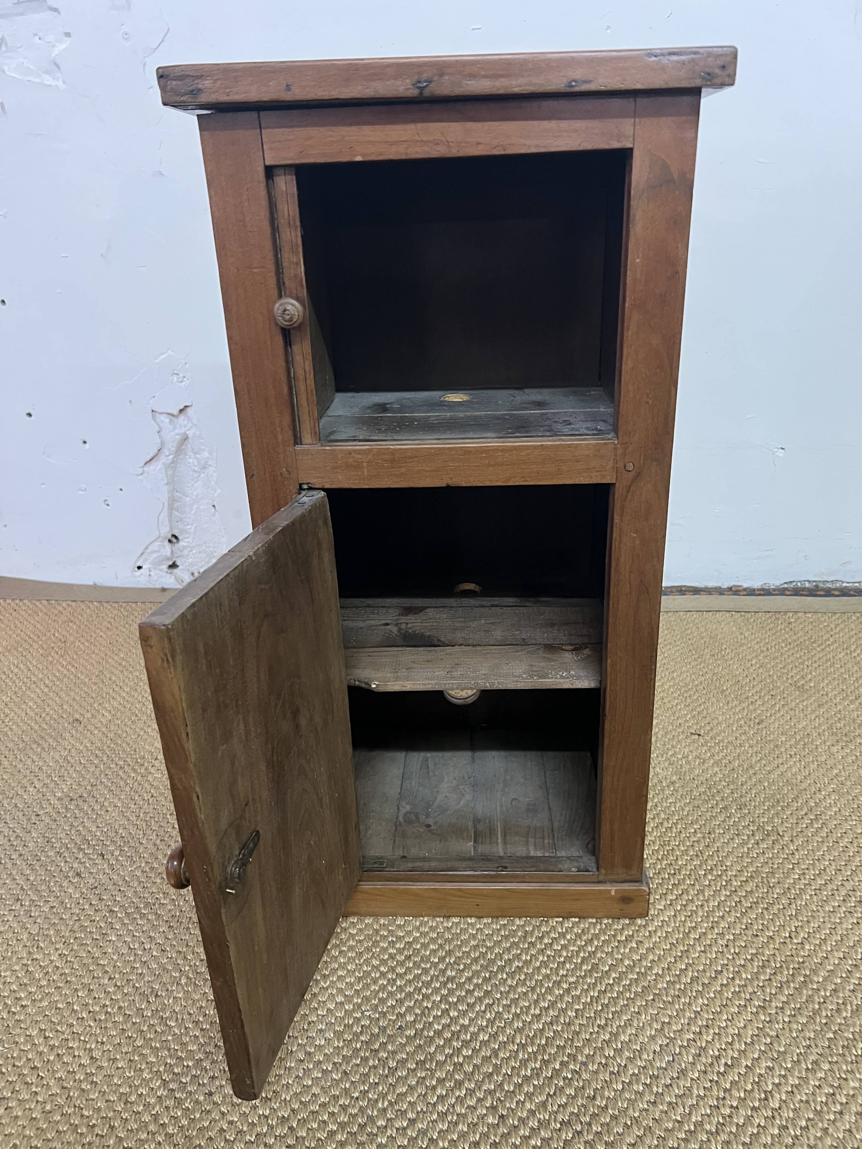 Old small storage unit with sliding and hinged doors.