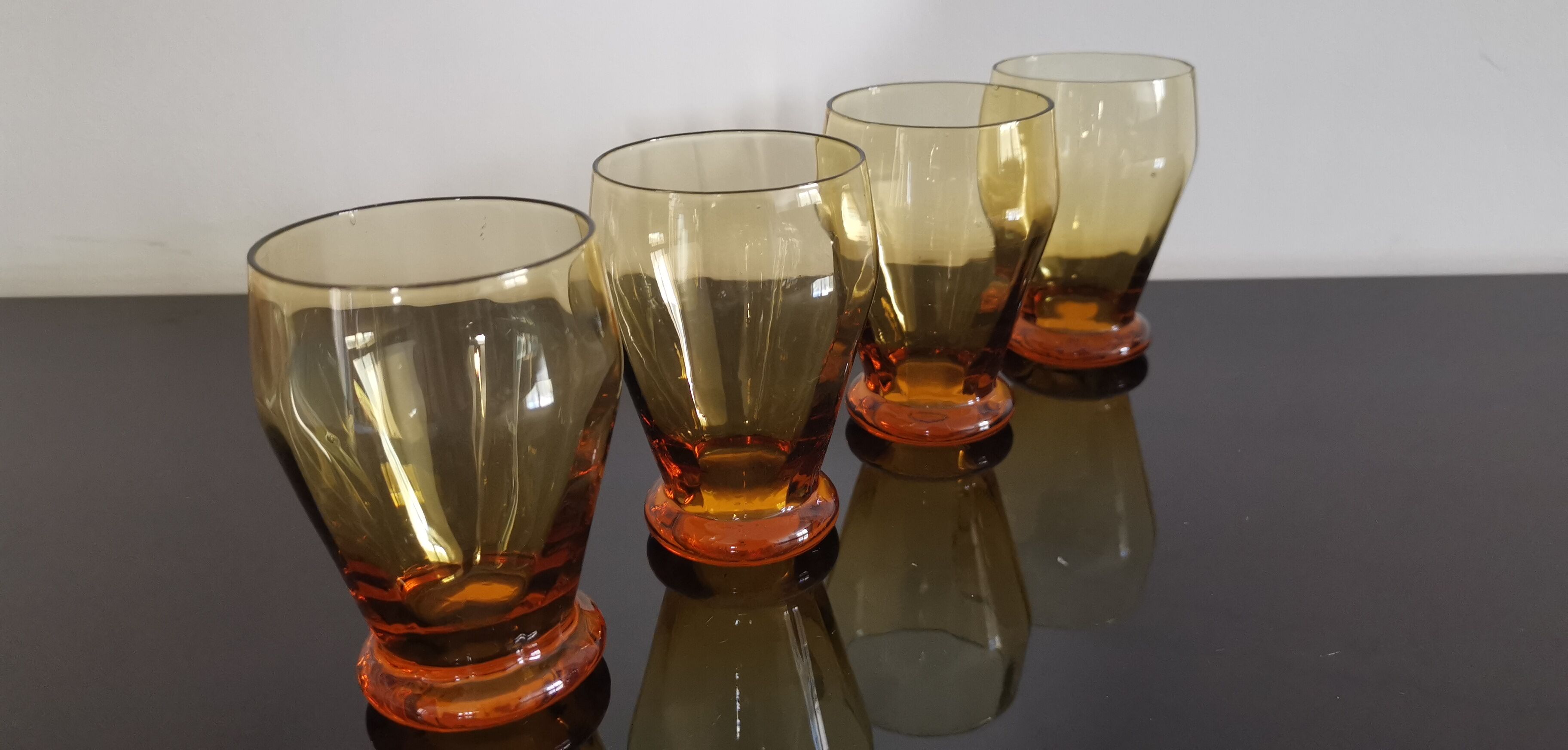 4 old amber colored glasses
