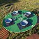 Antique round folding garden table with a green patina.