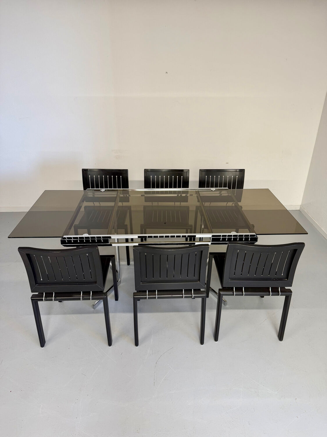 Smoked glass dining table with chrome legs, 1970s design by Roche Bobois.