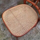 Pair of wooden and cane bistro chairs