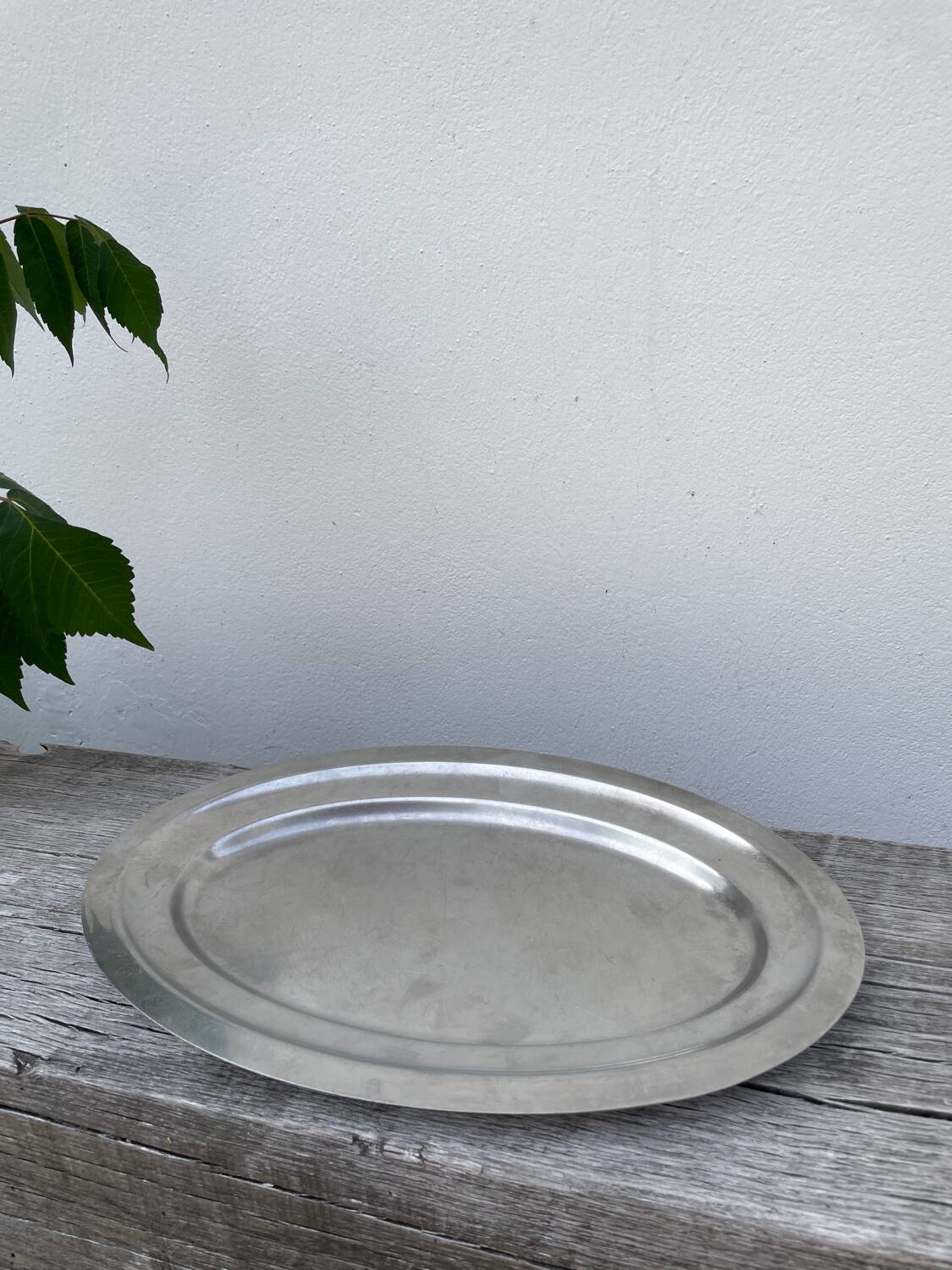 Oval stainless steel dish, signed Rémi Letang