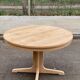 Scandinavian Baumann round extendable dining table with central leg, 115cm.