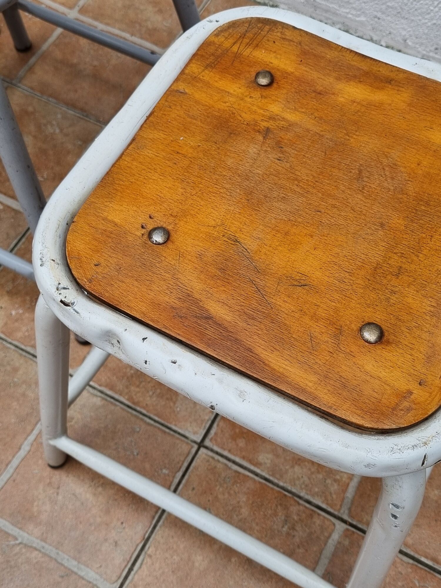 Set of four stackable industrial tubular metal and wood stools