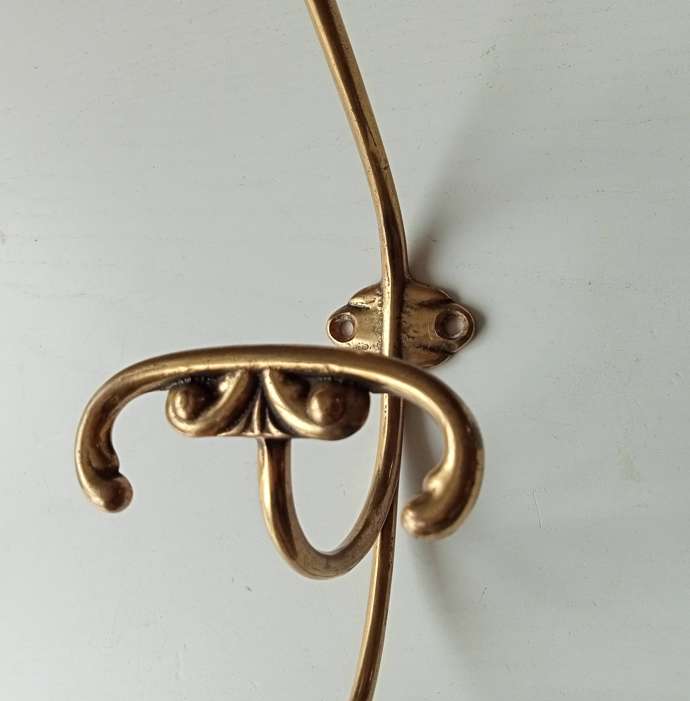 Old coat hook in solid golden brass