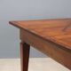 Antique Directoire table in walnut and cherry, Italy, 19th century.