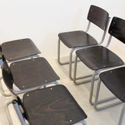 Ensemble de six chaises industrielles en contreplaqué Gispen dans un cadre gris et wengé.
