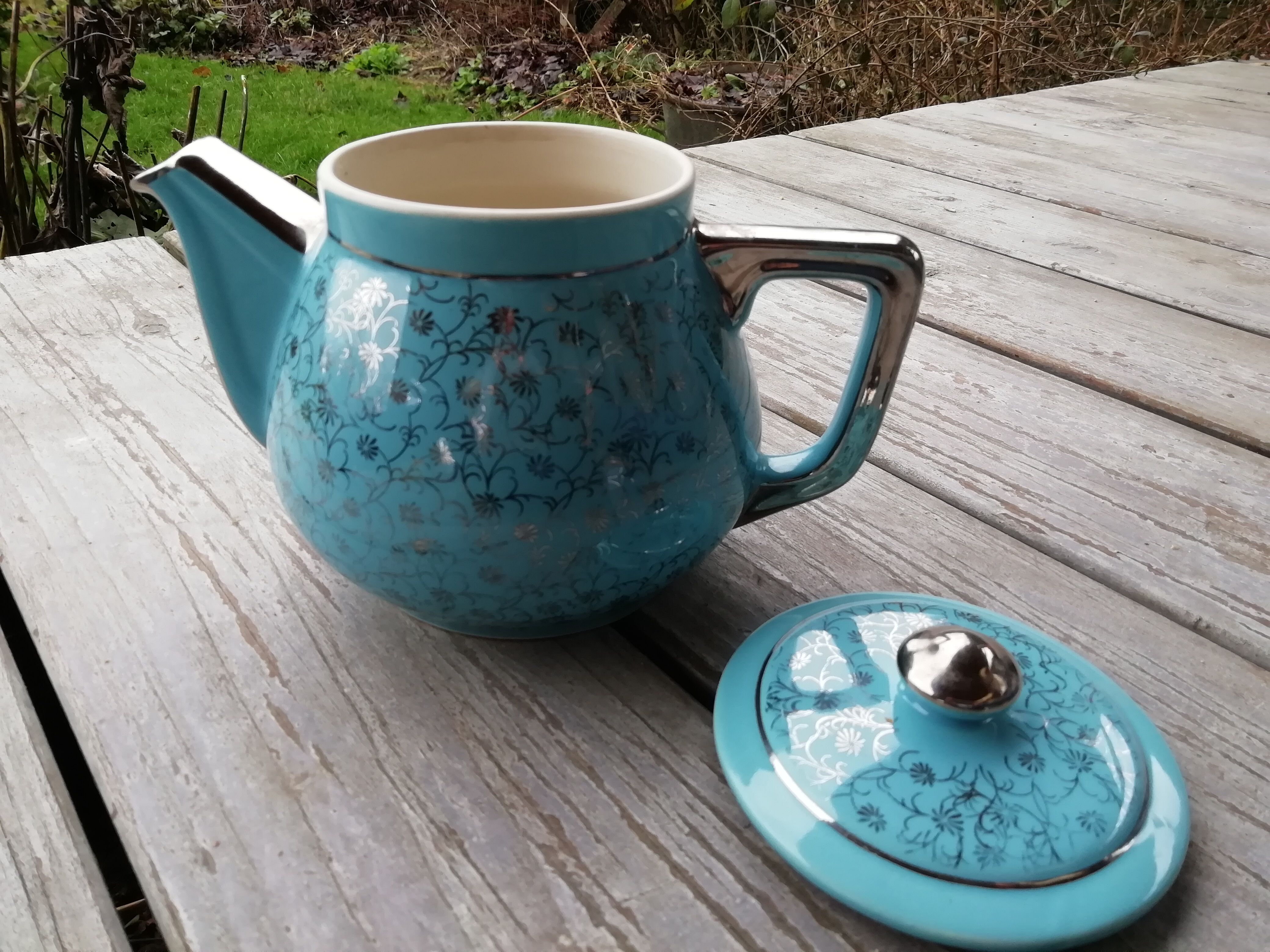 Semi blue teapot of silver flowers