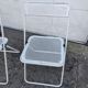 Set of three folding chairs with perforated metal.
