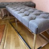 Pair of benches in chrome metal and padded gray fabric