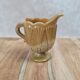 Small antique pressed glass jug in honey colour – moulded decoration