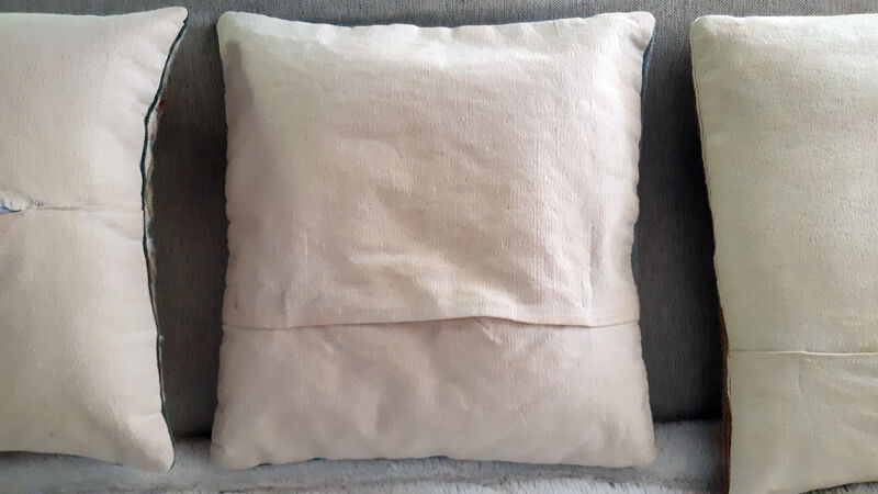 Set of three old hand-embroidered wool cushions