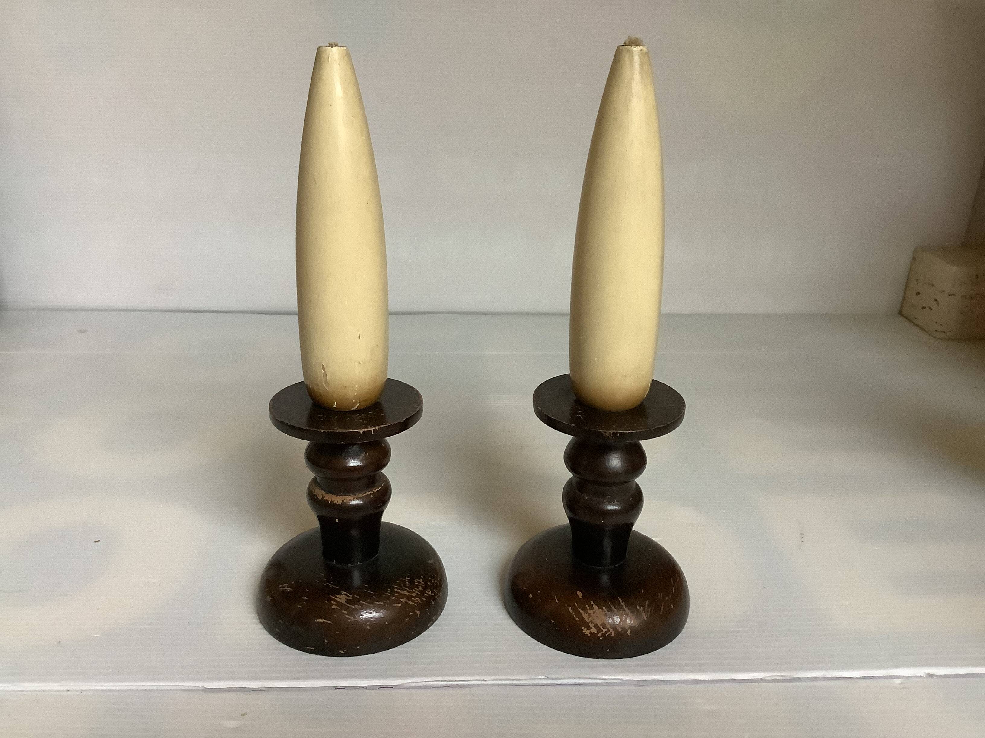 Pair of wooden candlesticks with fake wooden candles.