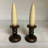 Pair of wooden candlesticks with fake wooden candles.
