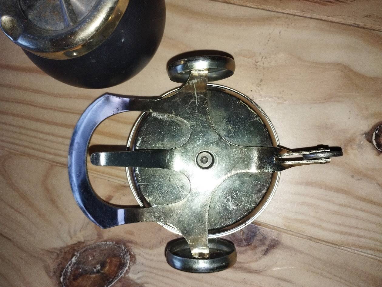 Original vintage ashtray on a small wheeled stand.