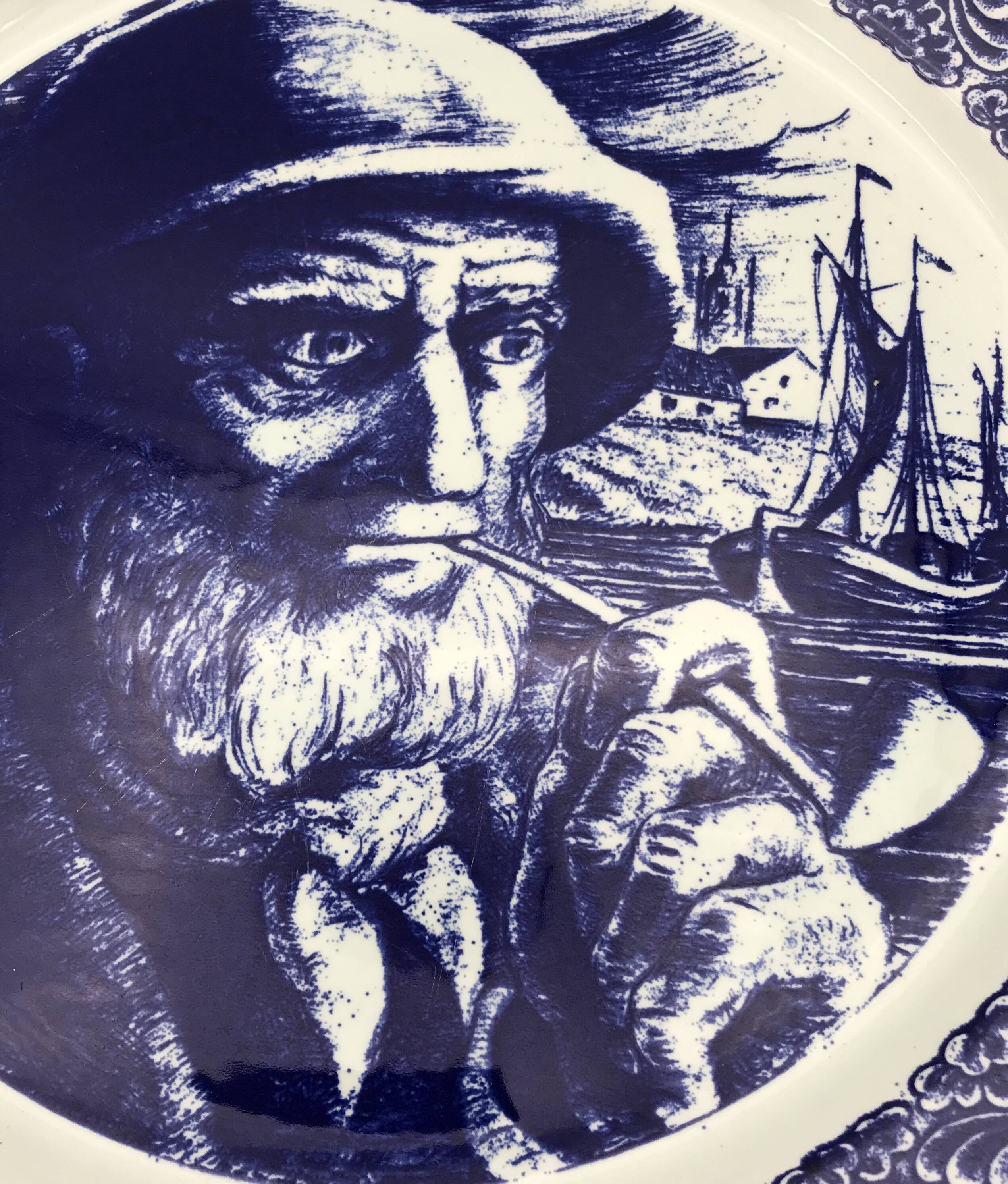 Blue enamelled earthenware wall plate with fisherman decor, Boch La Louvière, Belgium