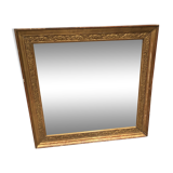 Old 19th century mirror in wood and gilded stucco