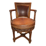 Antique swivel armchair in carved wood and patinated leather – neo-Renaissance style
